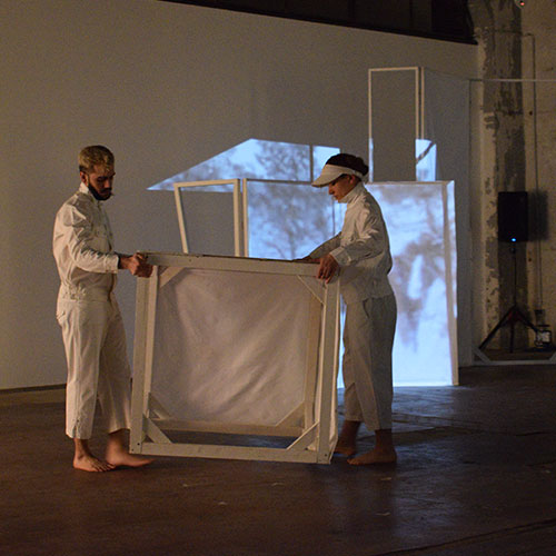 Two angels are carying and placing a set elements on the stage